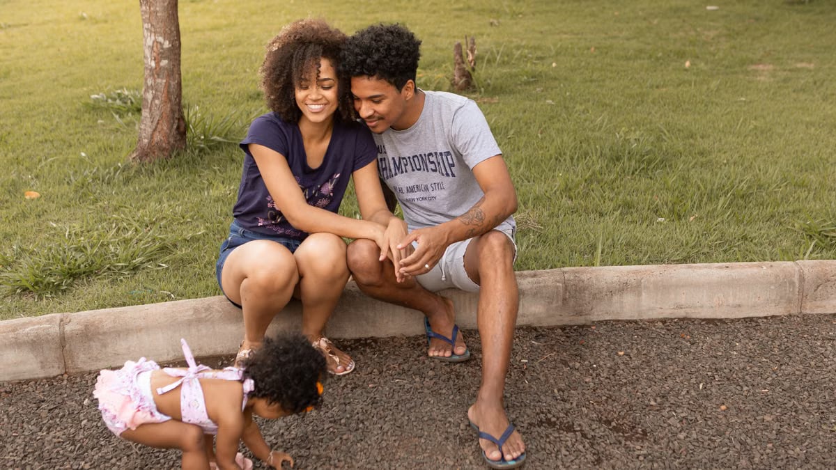 A joyful family enjoys quality time together outdoors on a sunny day at the park.